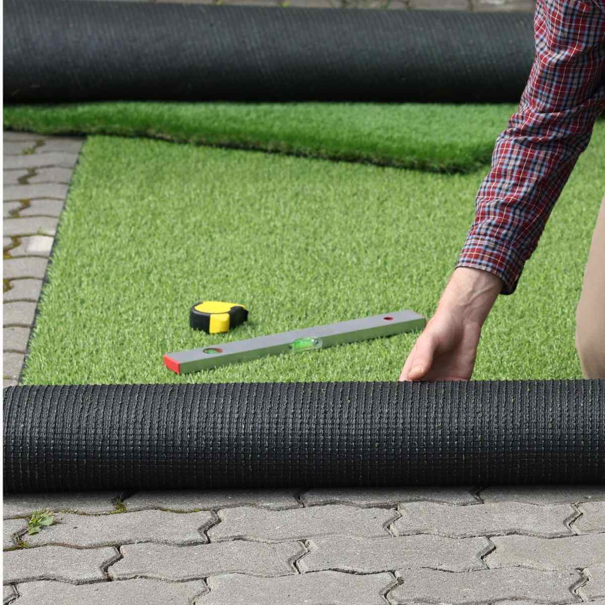 Architectural synthetic turf installation alongside modern house exterior